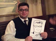 Вадим держит свой шарж на свадьбе
