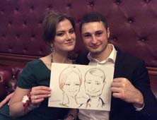 Танюша и Антон демонстрируют свой шарж от Мишеля
